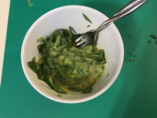 photo of eggs in bowl with spinach