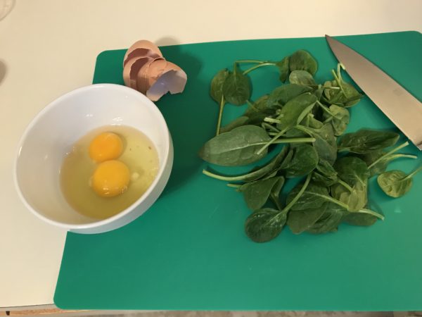 Photo of eggs in bowl and baby spinach